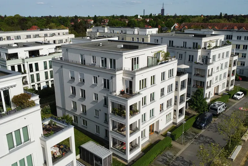 Aerial view of a bright residential building with roof terraces on Biesheimring, Berlin